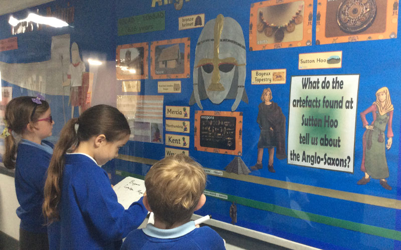 Students learning history together on a display about Anglo Saxons