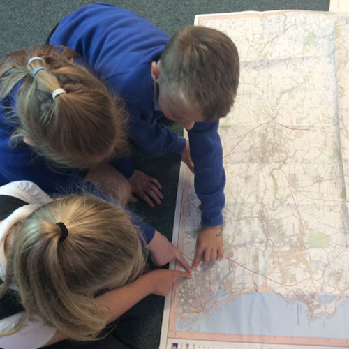 Students at St Wilfrids learning geography together using a map