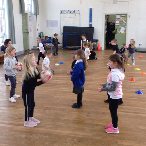 Students at St Wilfrids playing catch together in PE class